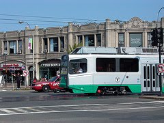 Color photograph of Boston T (electric train), Cleveland Circle line, crossing the Coolidge Corner intersection in Brookline, Mass. Photograph by Anna Cook, 2009.