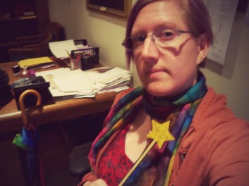 A bisexual as seen in the wild, with fairy wand and rainbow scarf, which I wore to my grandmother's funeral because Grandma always loved a spot of color.