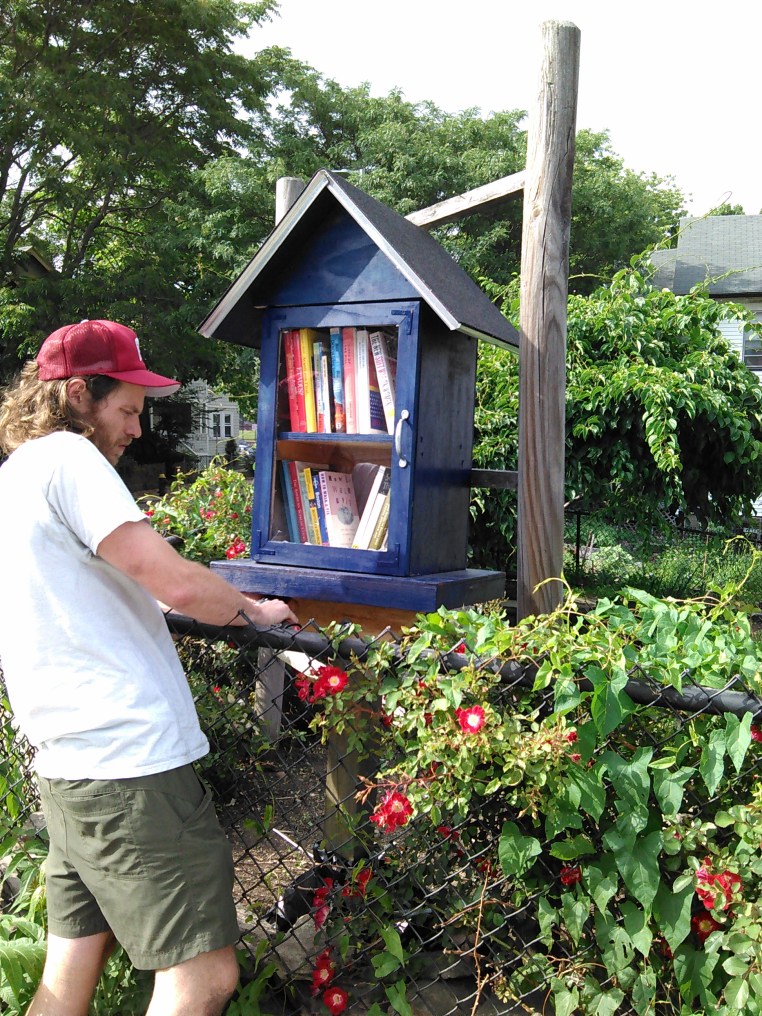 Matt, our neighbor, helping install our Little Free Library.